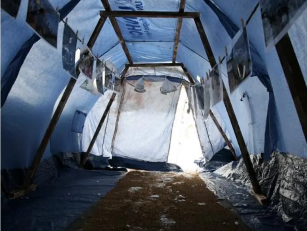 Interior of a standard-issue tent with no insulation, exposed to cold and damp